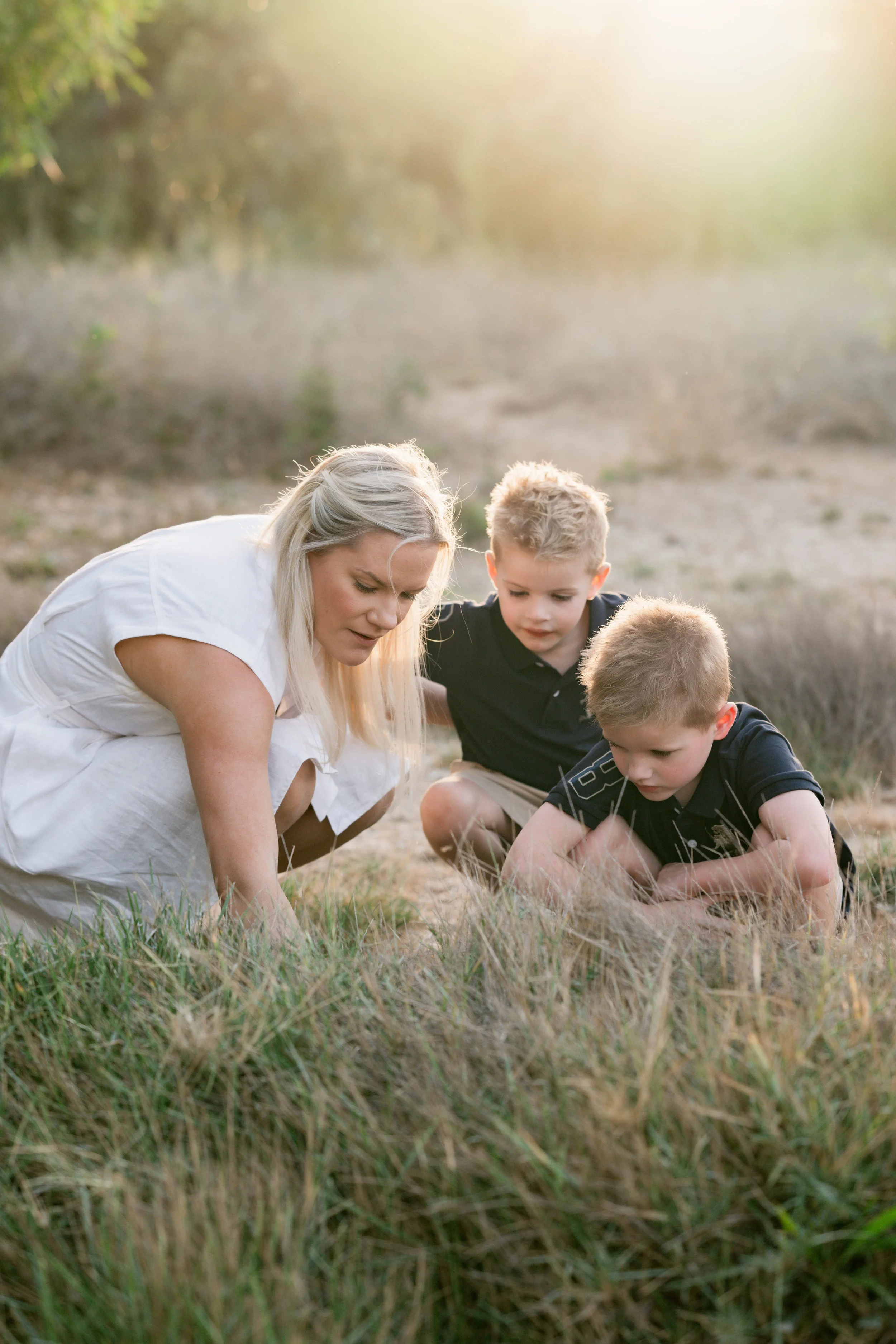 Mother exploring with her children during a sunset family photography session at Al Qudra Lakes in Dubai.
