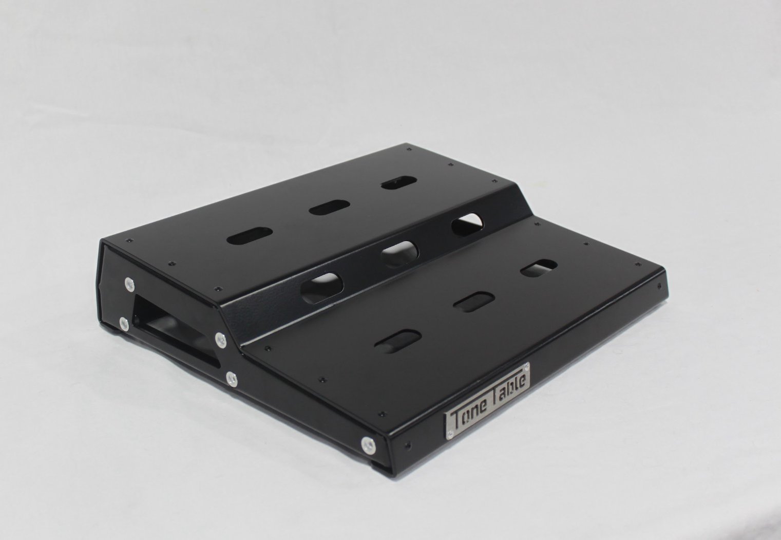 Black metal dropper seatpost with multiple cutouts and mounting hardware on a white background.