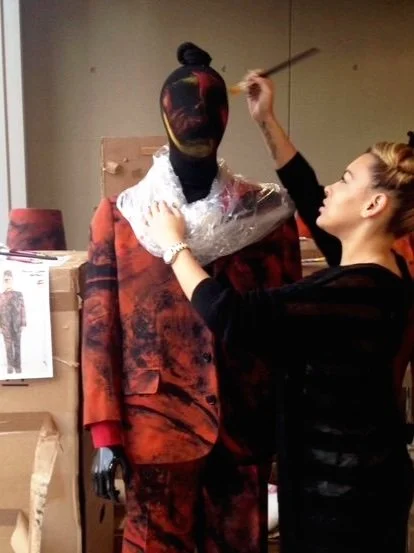 handpainting costume accessories to blend the mannequins for the exhibition