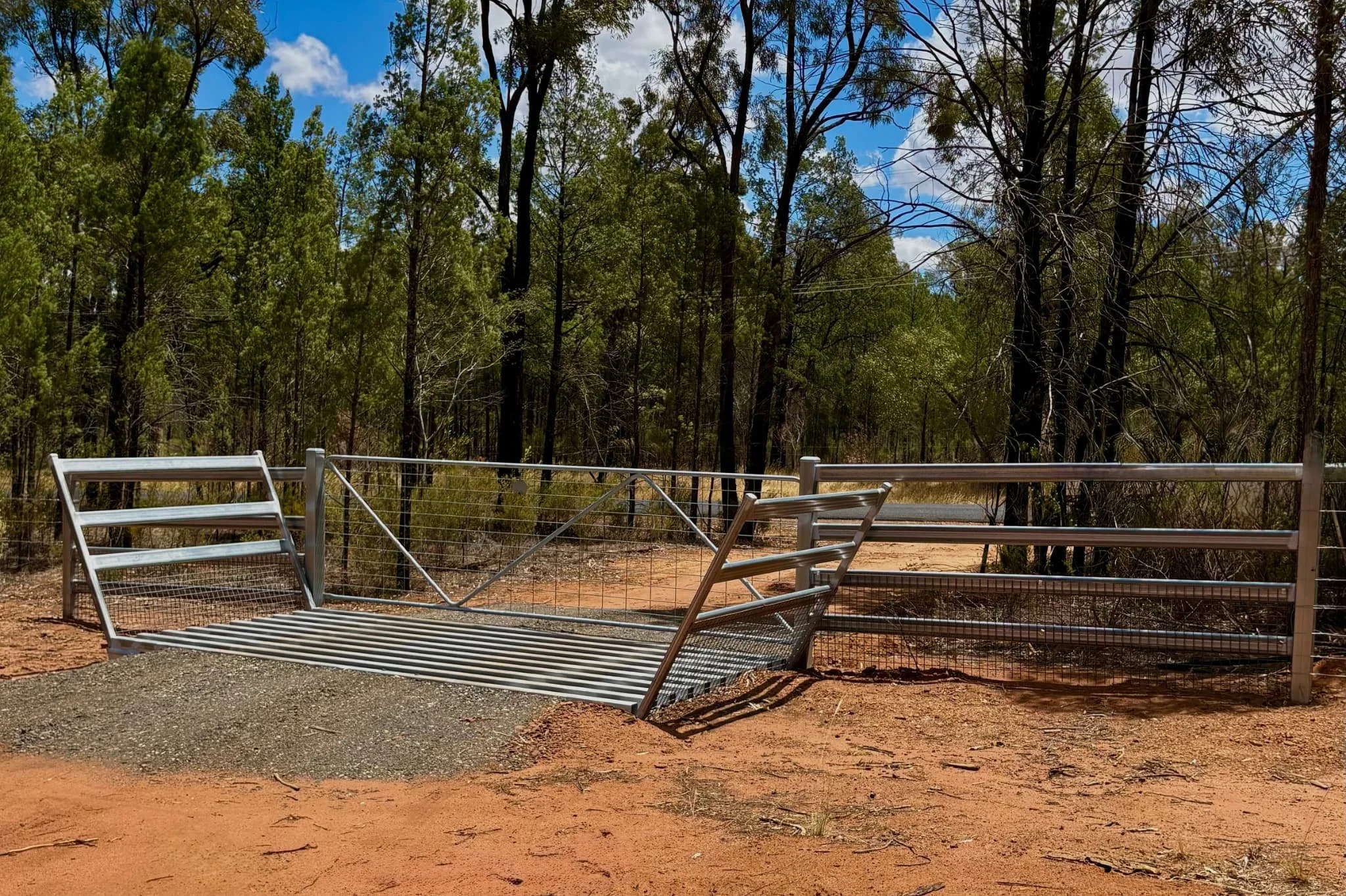 Galvanised cattle gris with swing gates and cattle rail installed on rural property, TG Wheeler Contracting NSW