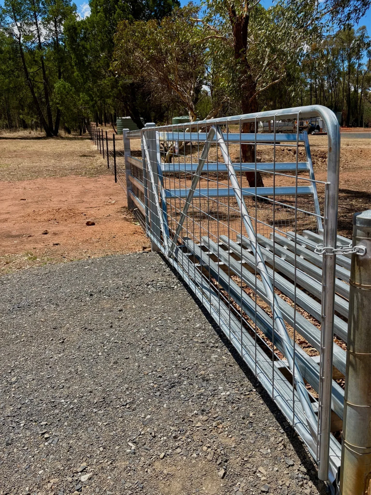 Close-up of galvanised front farm gate and cattle grid on rural property, TG Wheeler Contracting NSW