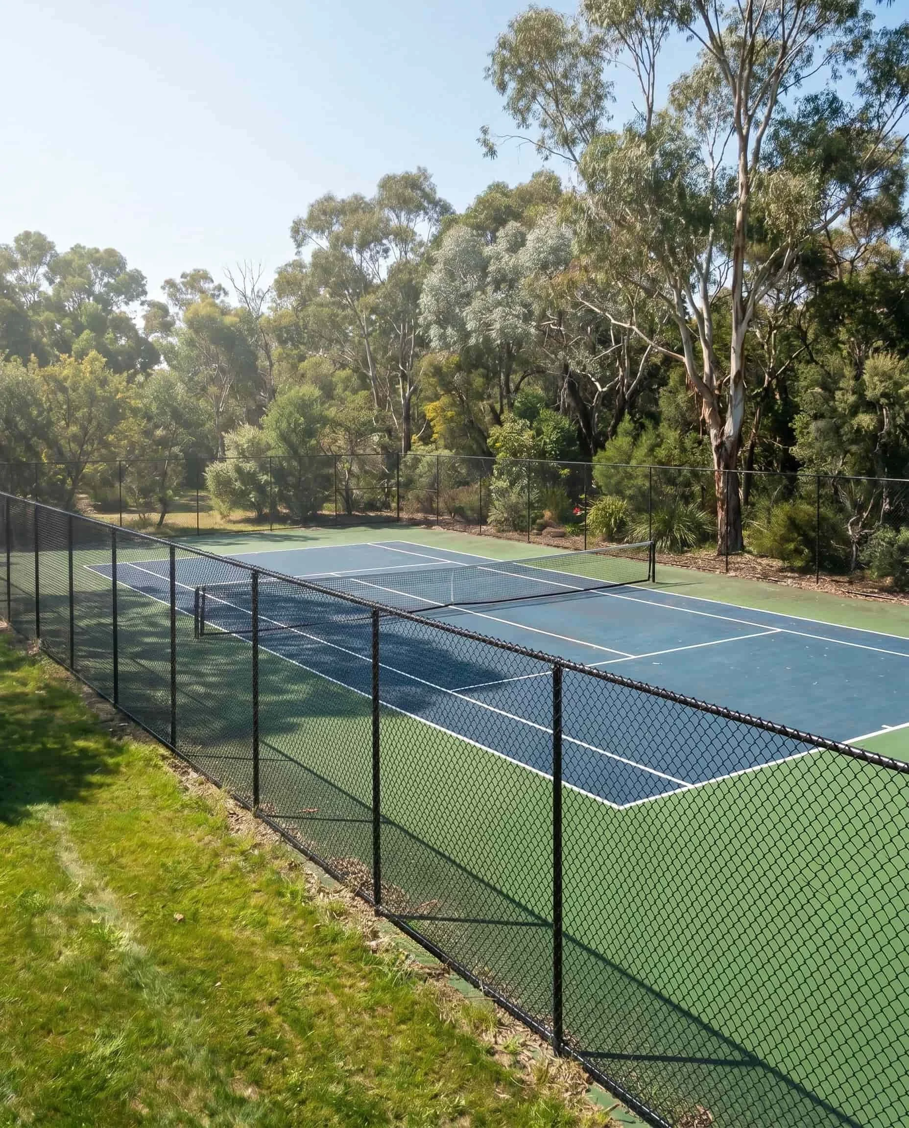 Elevated view of black chainwire tennis court fencing on hard court, TG Wheeler Contracting NSW