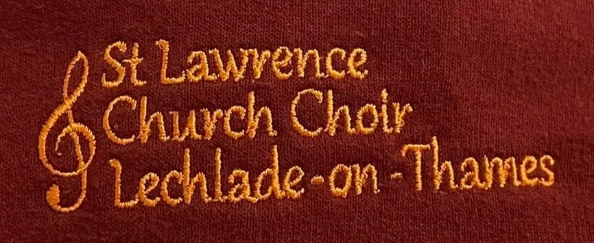 Embroidery text reading 'St Lawrence Church Choir Lechlade-on-Thames' on a burgundy fabric background.