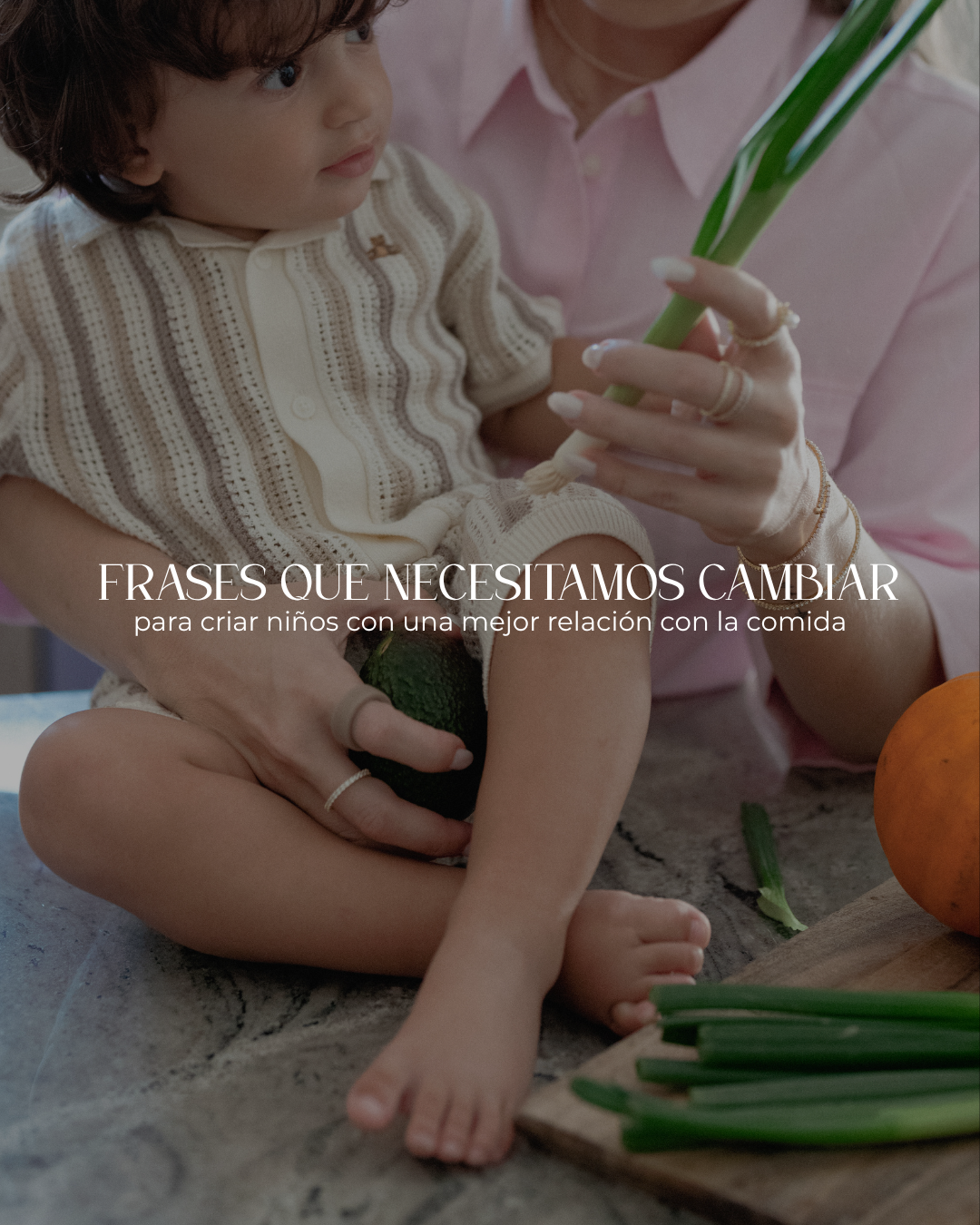 Vicky sostiene a su hijo noa mientras le enseña algunos vegetales