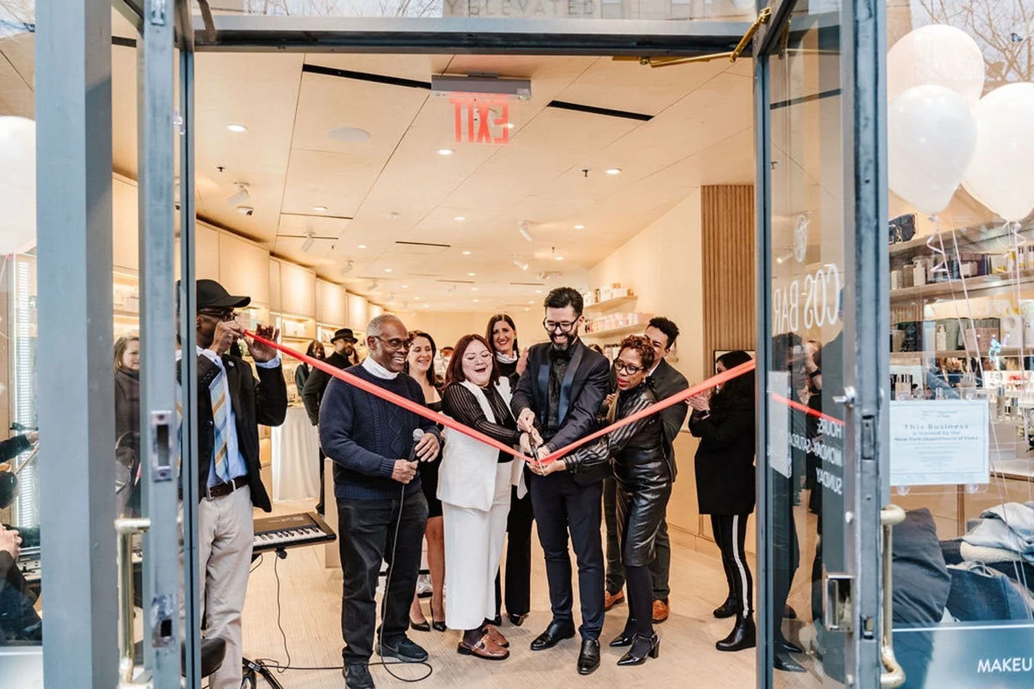group of people during ribbon cutting for Cos Bar
