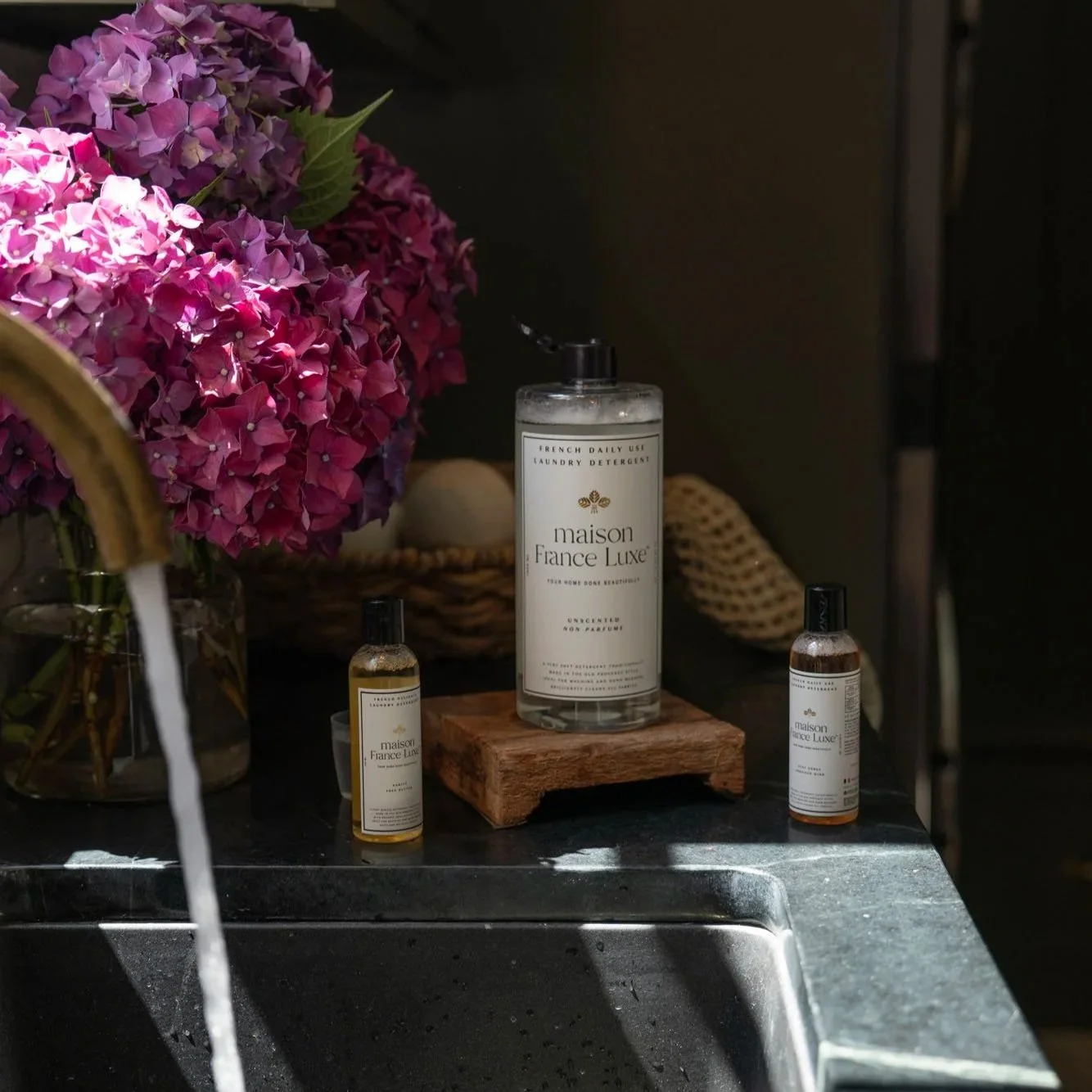 Maison France Luxe soap bottle by wink with flowers in background