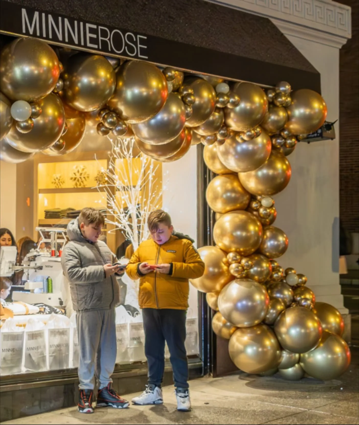 two people standing outside Minnie Rose store opening event