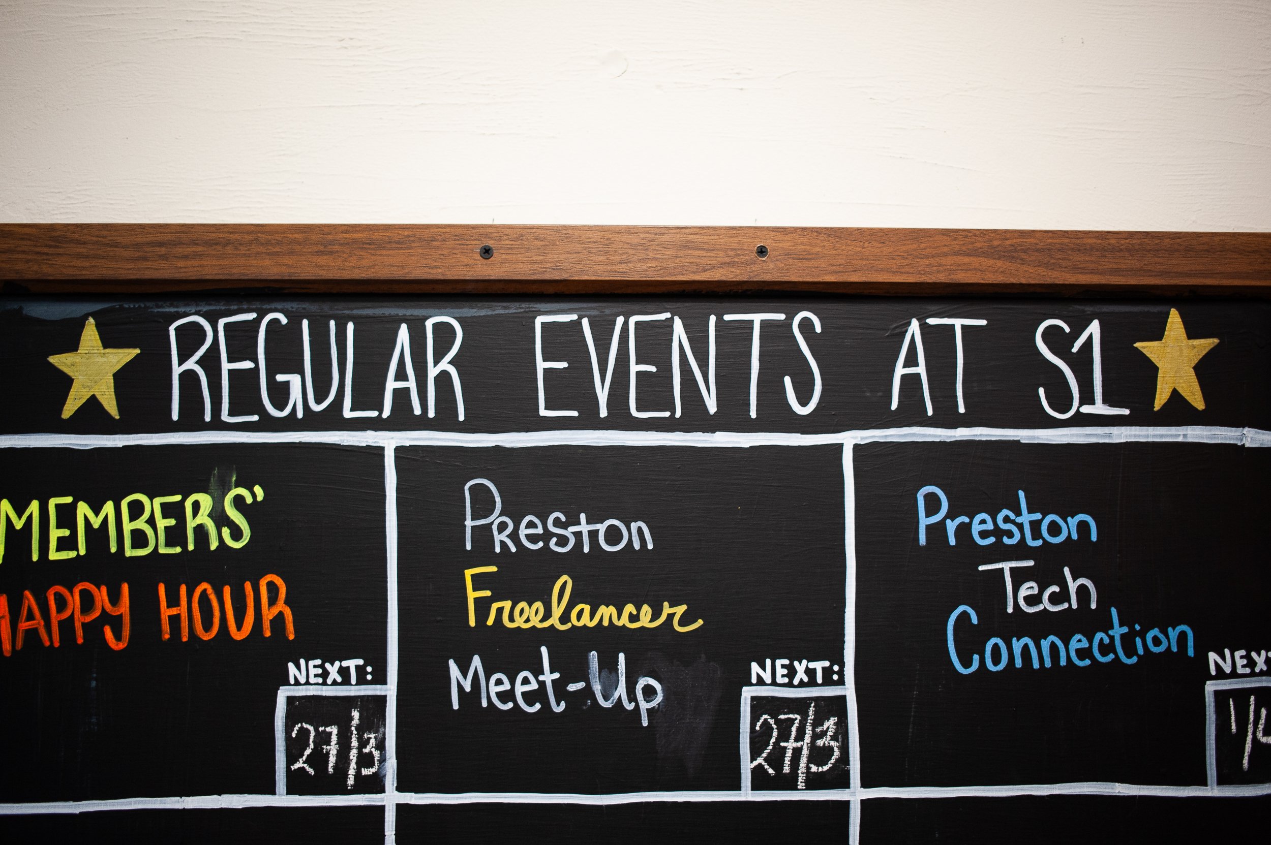 Chalkboard with 'Regular Events at S1' and event listings: Members' Happy Hour, Preston Freelancer Meet-Up, and Preston Tech Connection, with dates for each event.