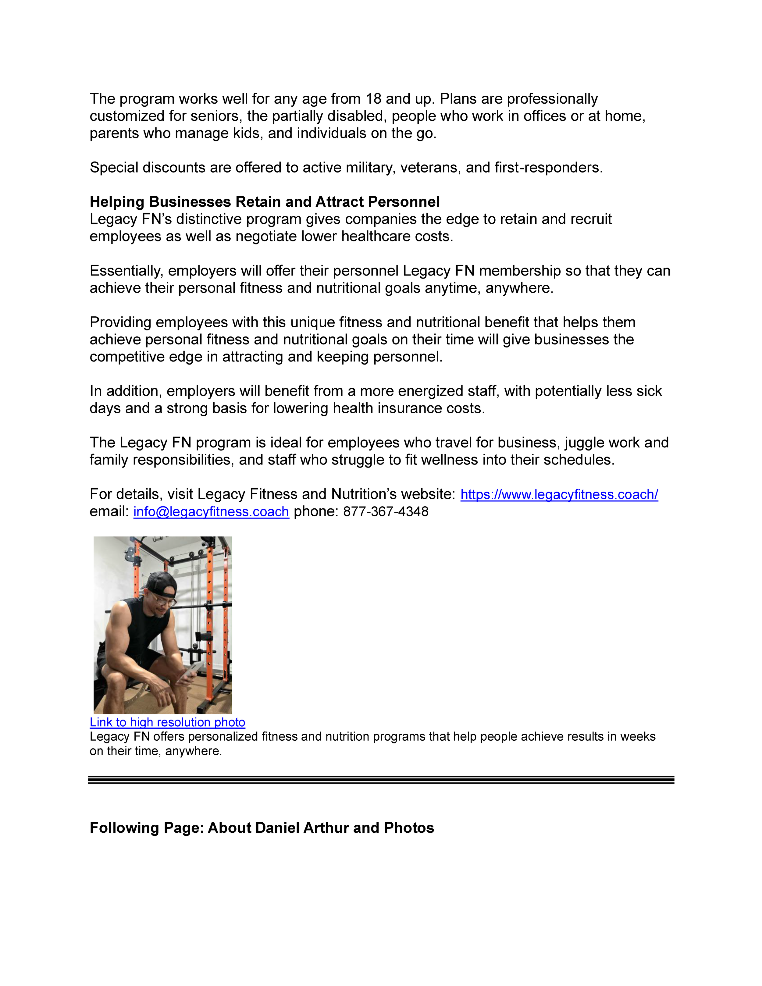 A person in workout gear, sitting in a gym, looking at their phone near a squat rack.