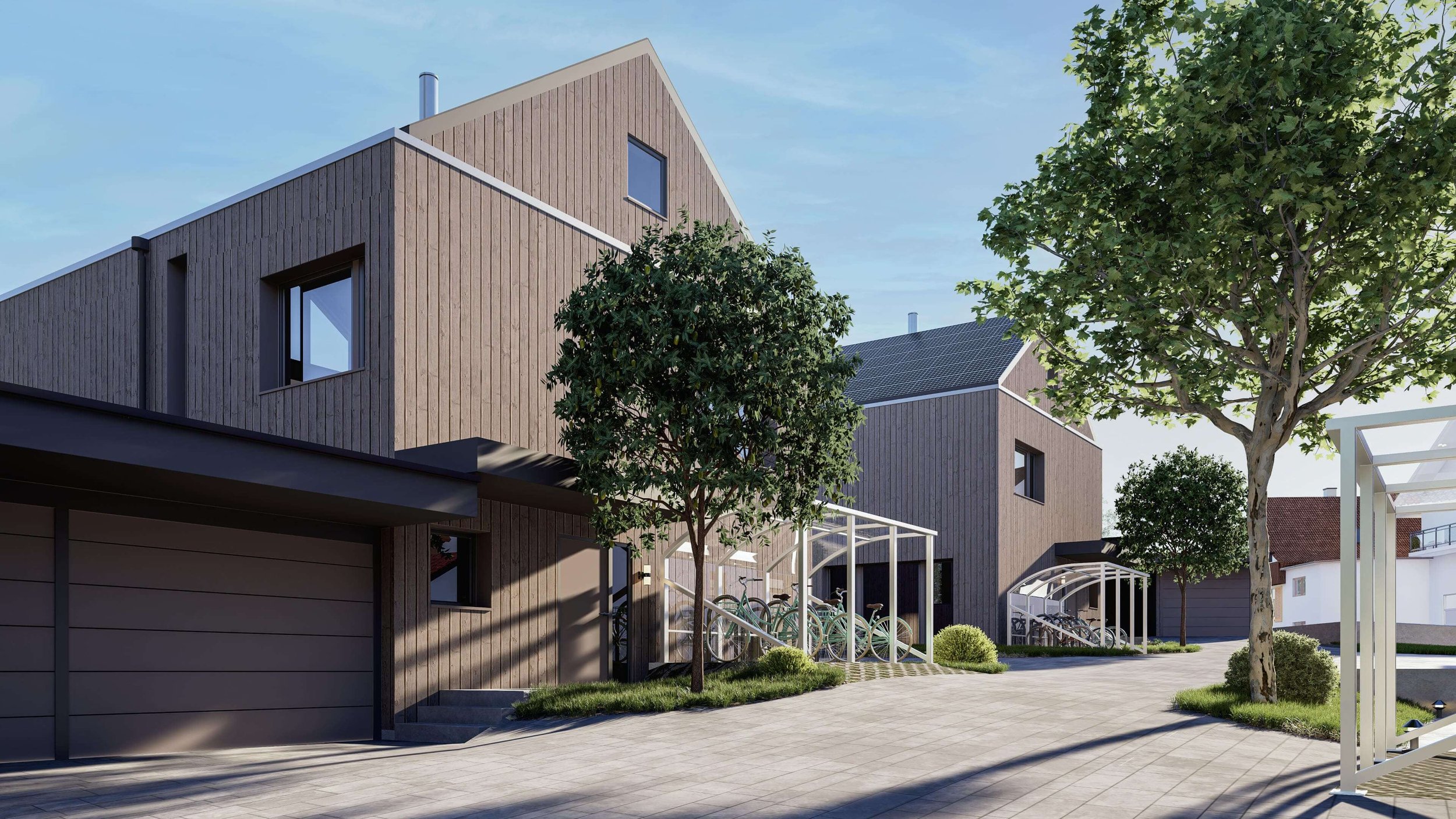 Moderne Wohnhäuser mit Holzfassade, Bänken, Fahrradspeicher und Bäumen in einer ruhigen Wohngegend bei sonnigem Himmel.