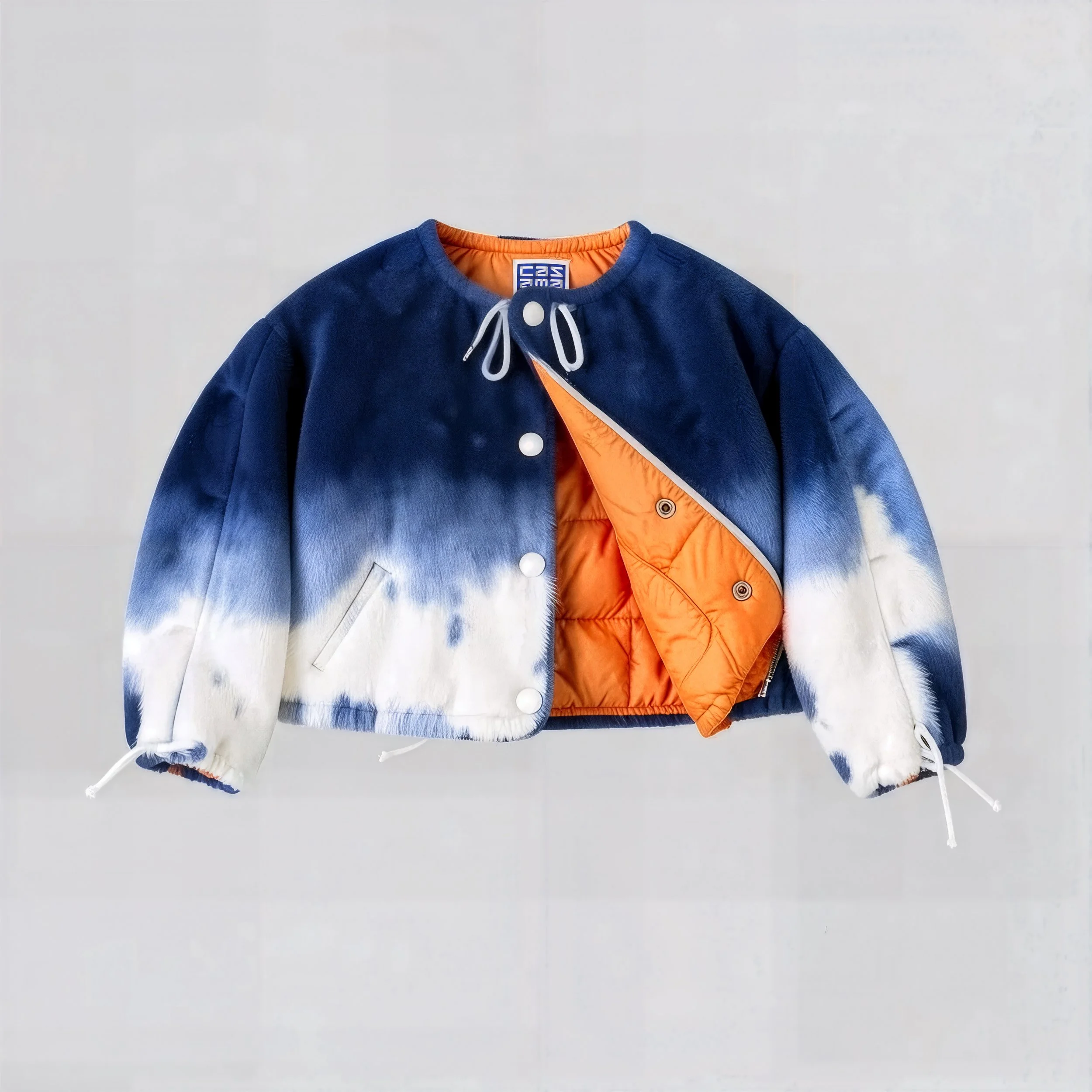 Blue and white tie-dye jacket with orange lining, snap buttons, and drawstring cuffs.