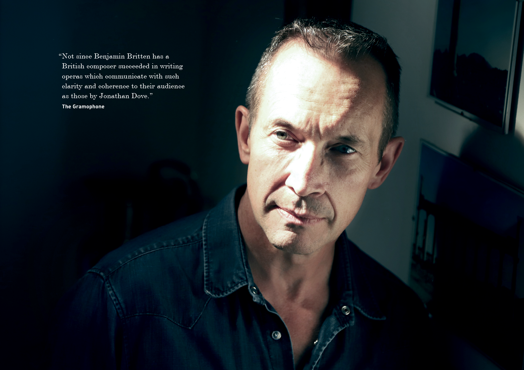 Portrait of a middle-aged man with short hair, wearing a dark shirt, looking slightly to the right, with a quote on the left side of the image.