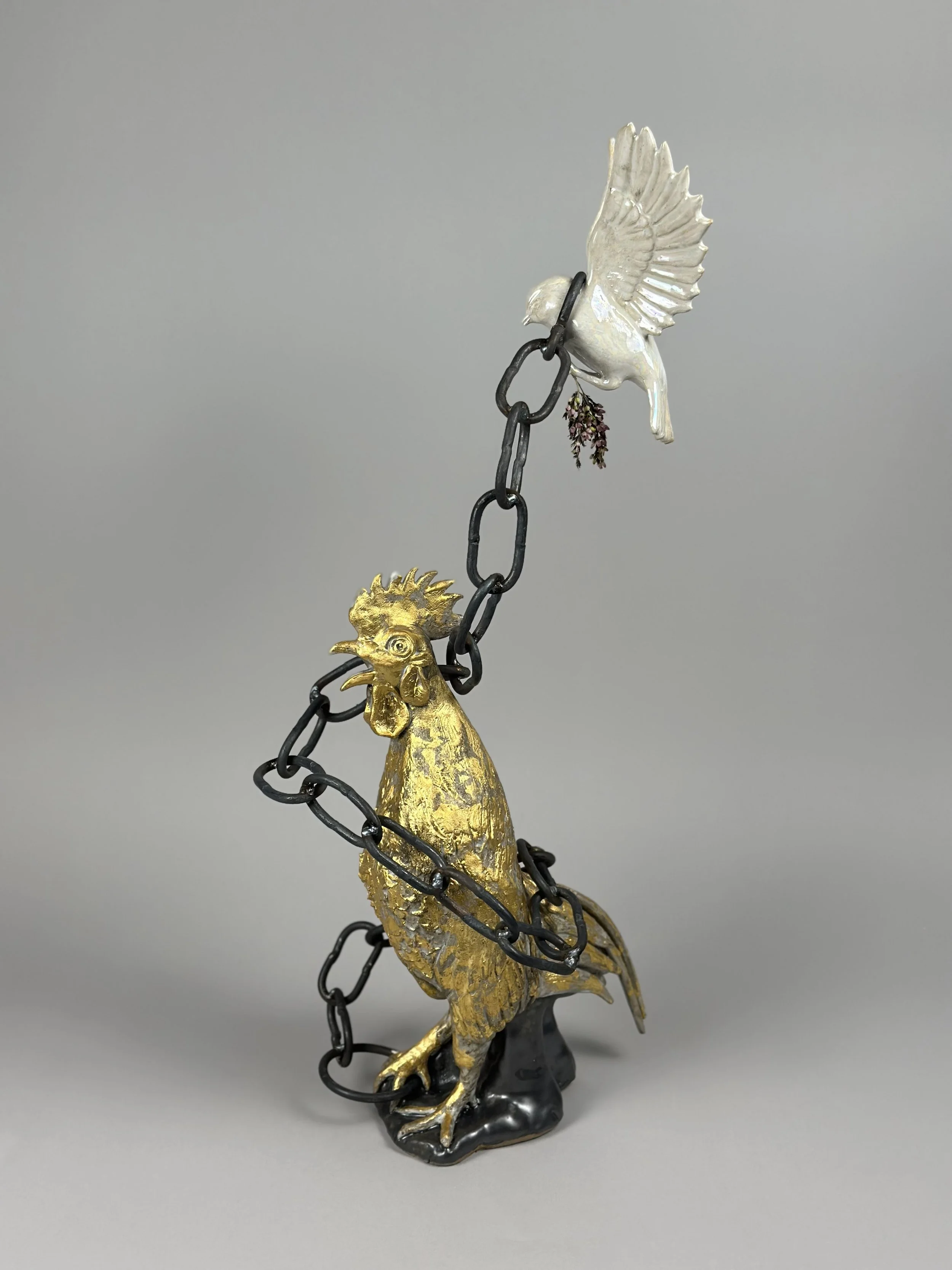 A Songbird and the Cock 
2025 
25" x 9" x 12"
ceramic, glaze, hand-forged steel, 24k gold leaf, dried flowers