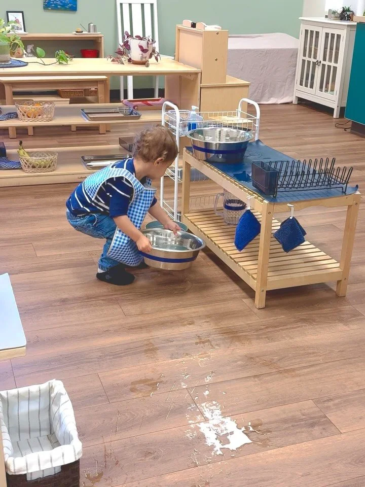✨ Learning in every pour ✨

This child is carefully pouring the dishwashing basins into a bucket. You may notice a bit of water on the floor&mdash;this, too, is part of the learning process. In Montessori, purposeful, hands-on work allows children to