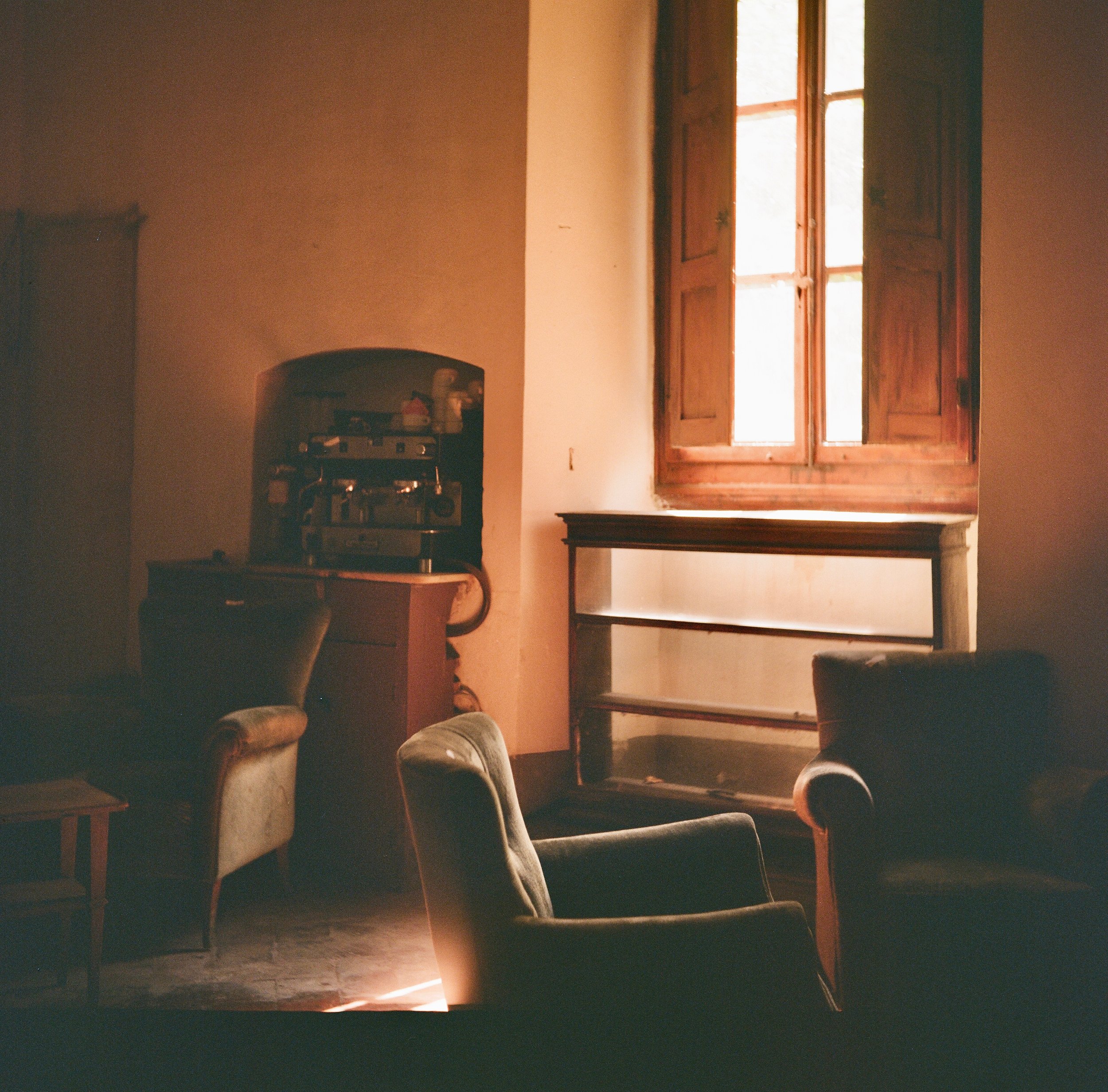 a "salotto" in a now deserted family house. despite its barrenness, there is less melancholy about what's missing, and more a sense of gratitude that light can still live here.
