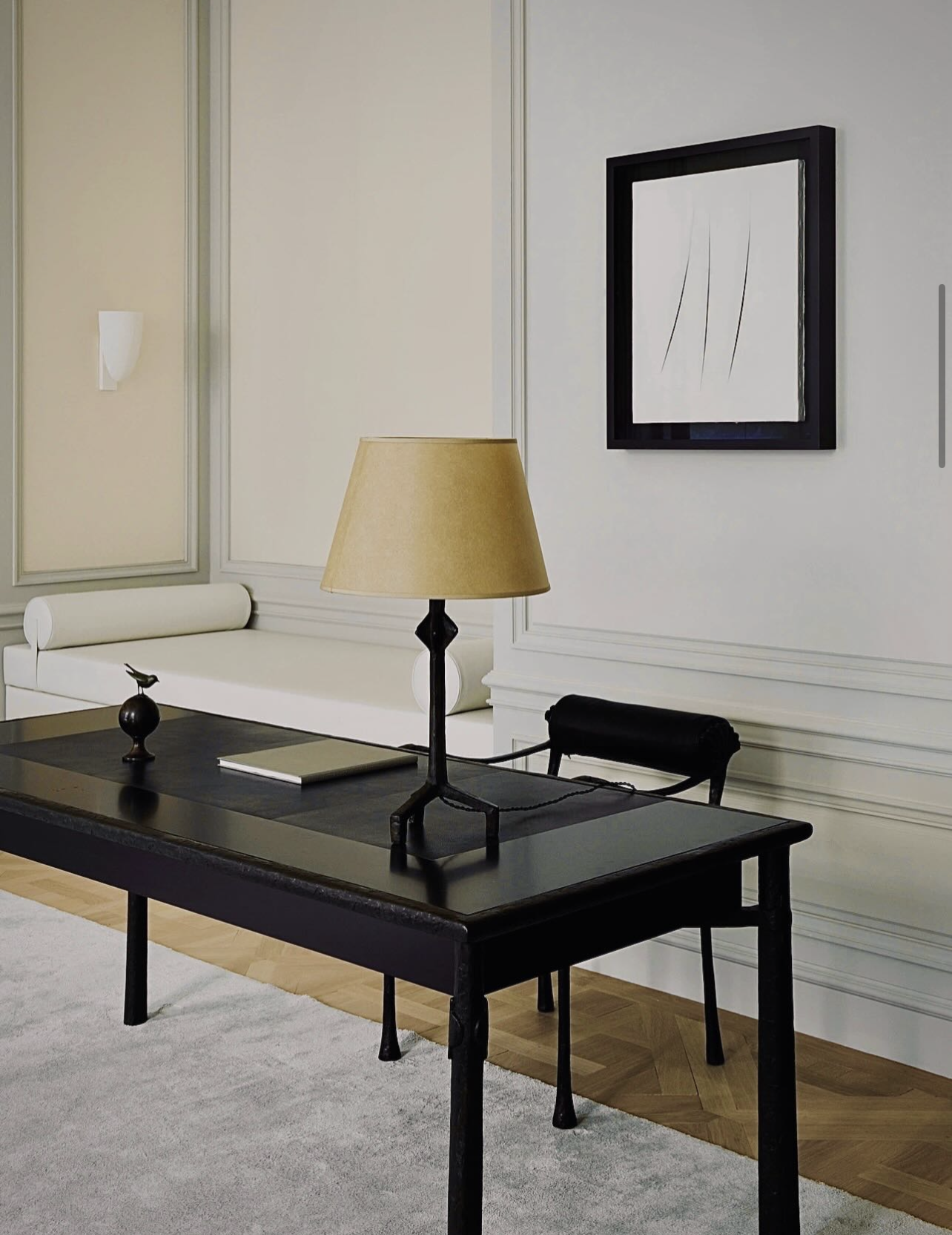 Minimal interior with a black desk and lamp, editorial and content work