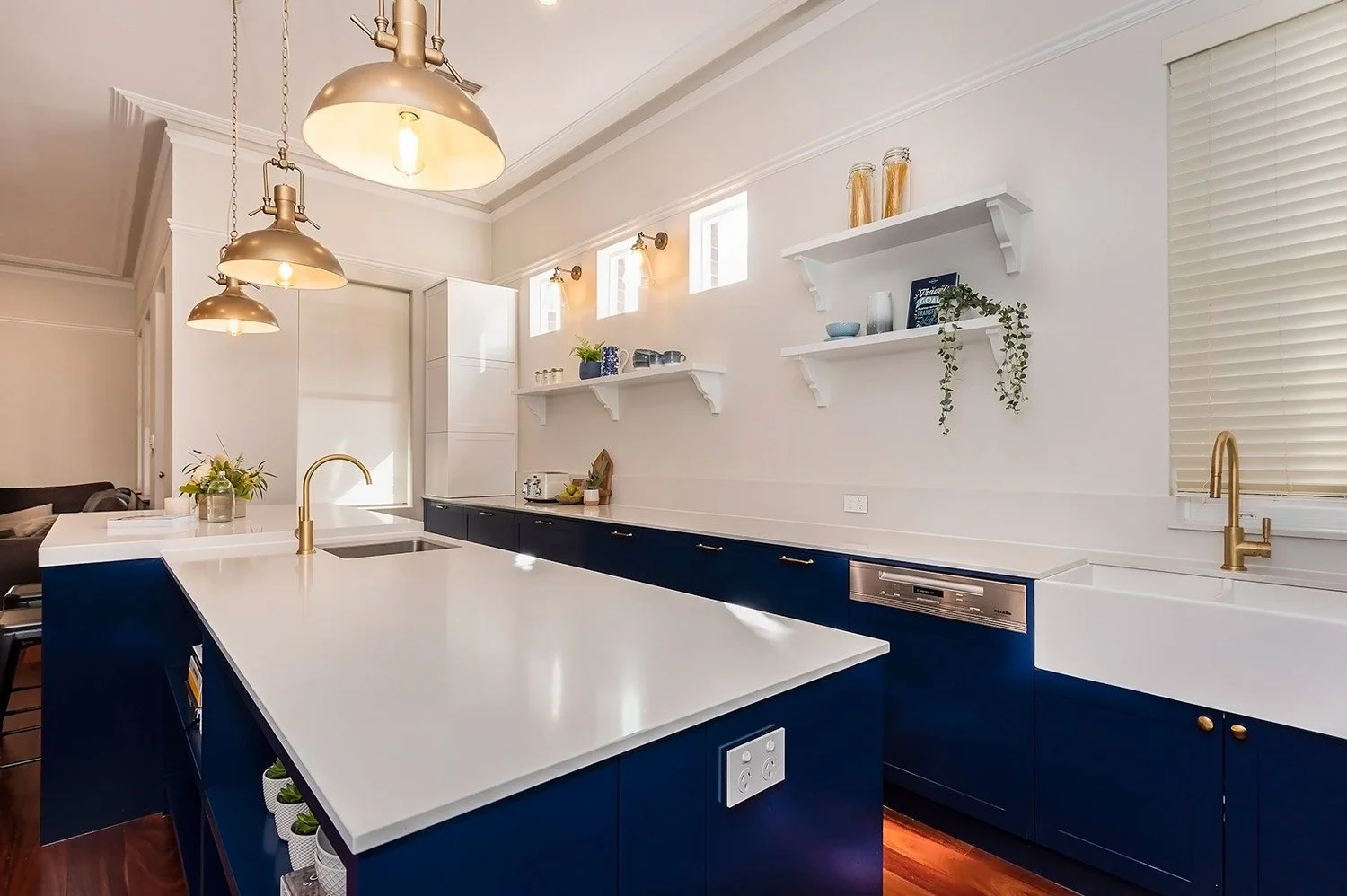 West Leederville home with classic navy blue kitchen cabinetry and brass accents