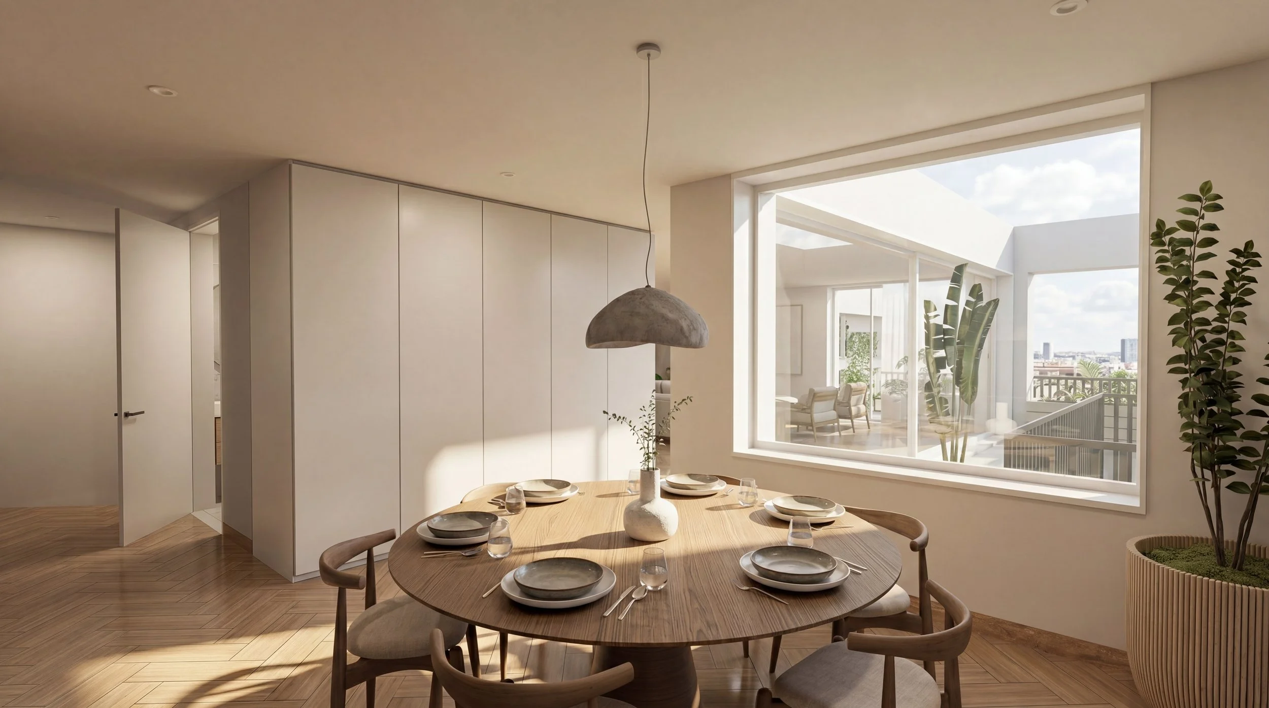 Modern dining room with a round wooden table set for six, a large window with views of an outdoor balcony with chairs and plants, and a ceiling light fixture.