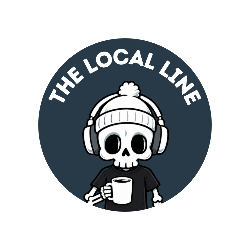 A cartoon skeleton wearing a winter hat with pom-pom, headphones, and a black T-shirt, holding a coffee mug. The background has a circular badge with the text "The Local Line."