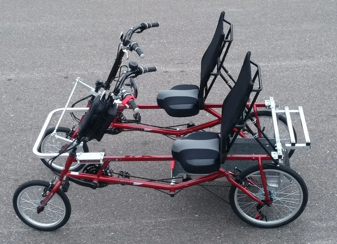 A four-wheeled red bike