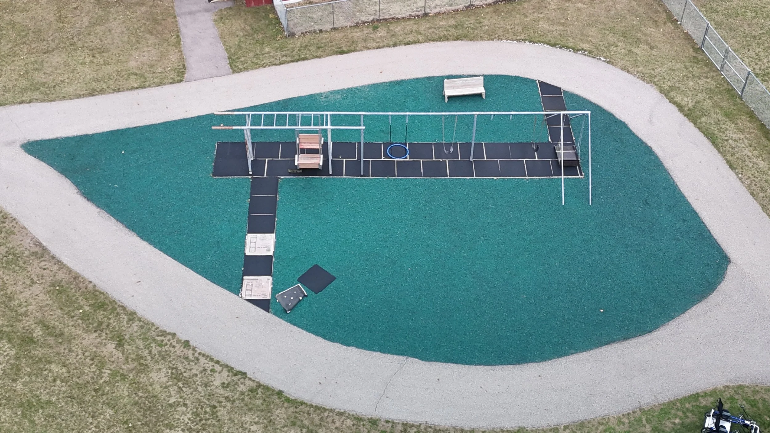 An aerial view of a green teardrop shape that includes the farm's current swingset
