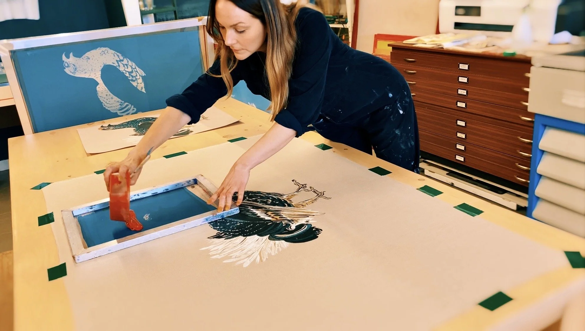 Lynsey Jean Henderson screen printing a bird design in her Edinburgh studio