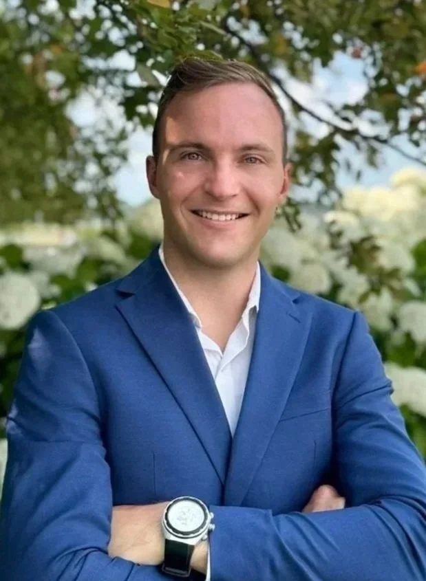 Black silhouette of a person with arms crossed against a white background.