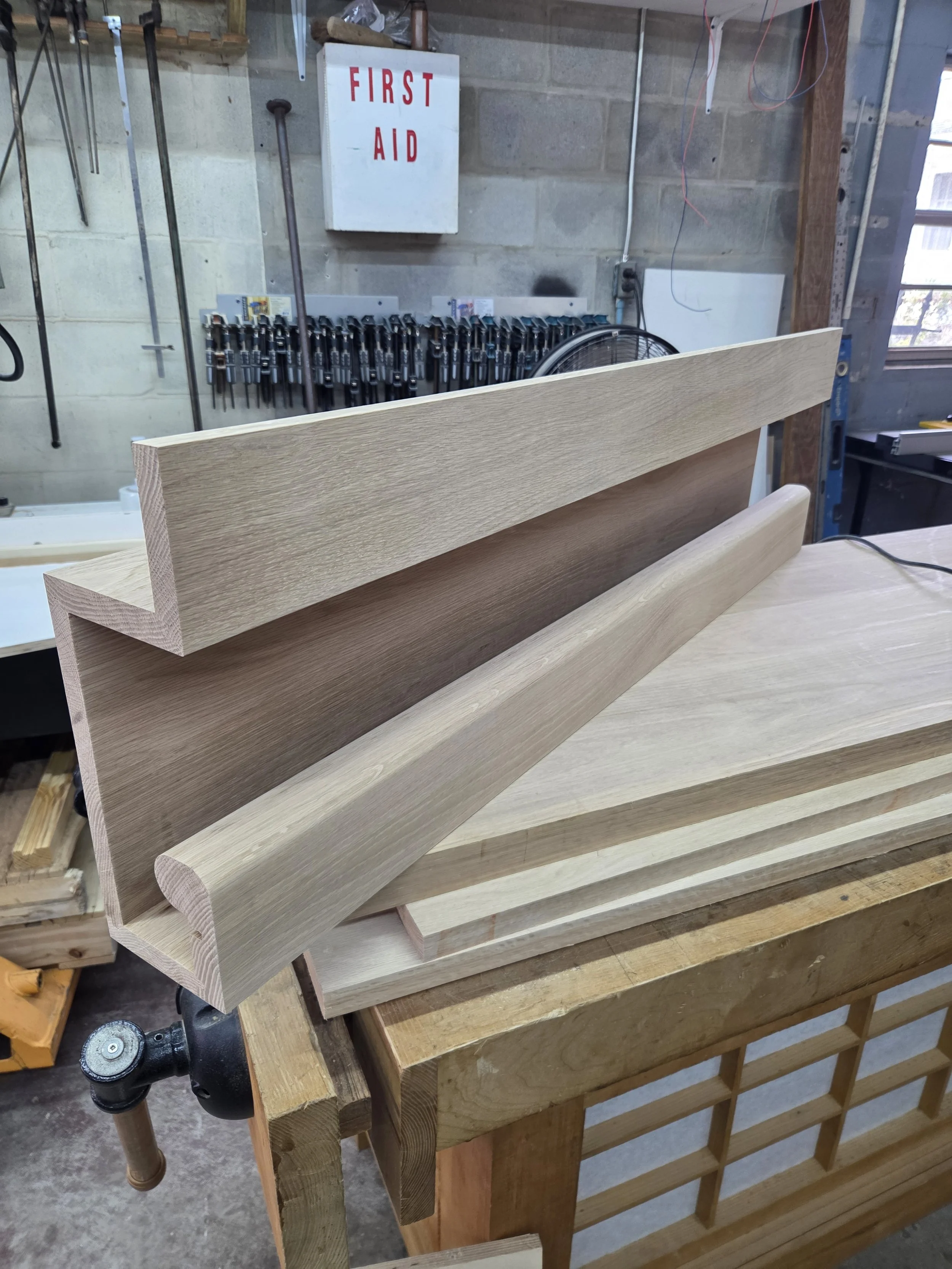Woodworking shop with stained wooden boards and tools.