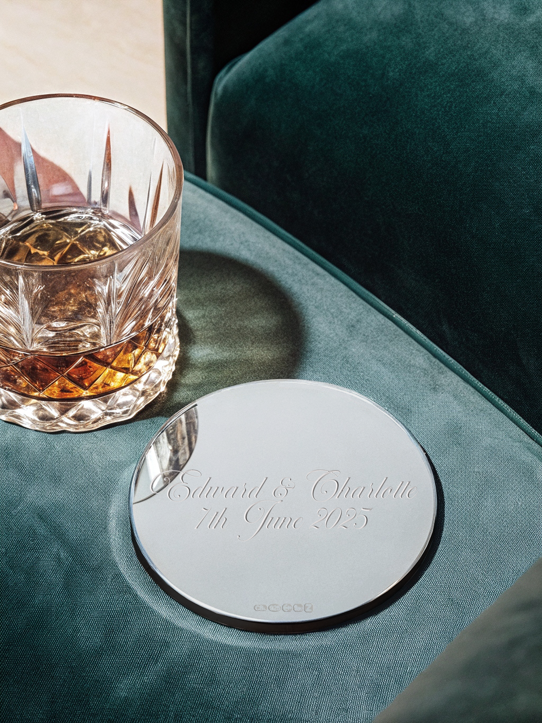 Personalised silver coaster being used