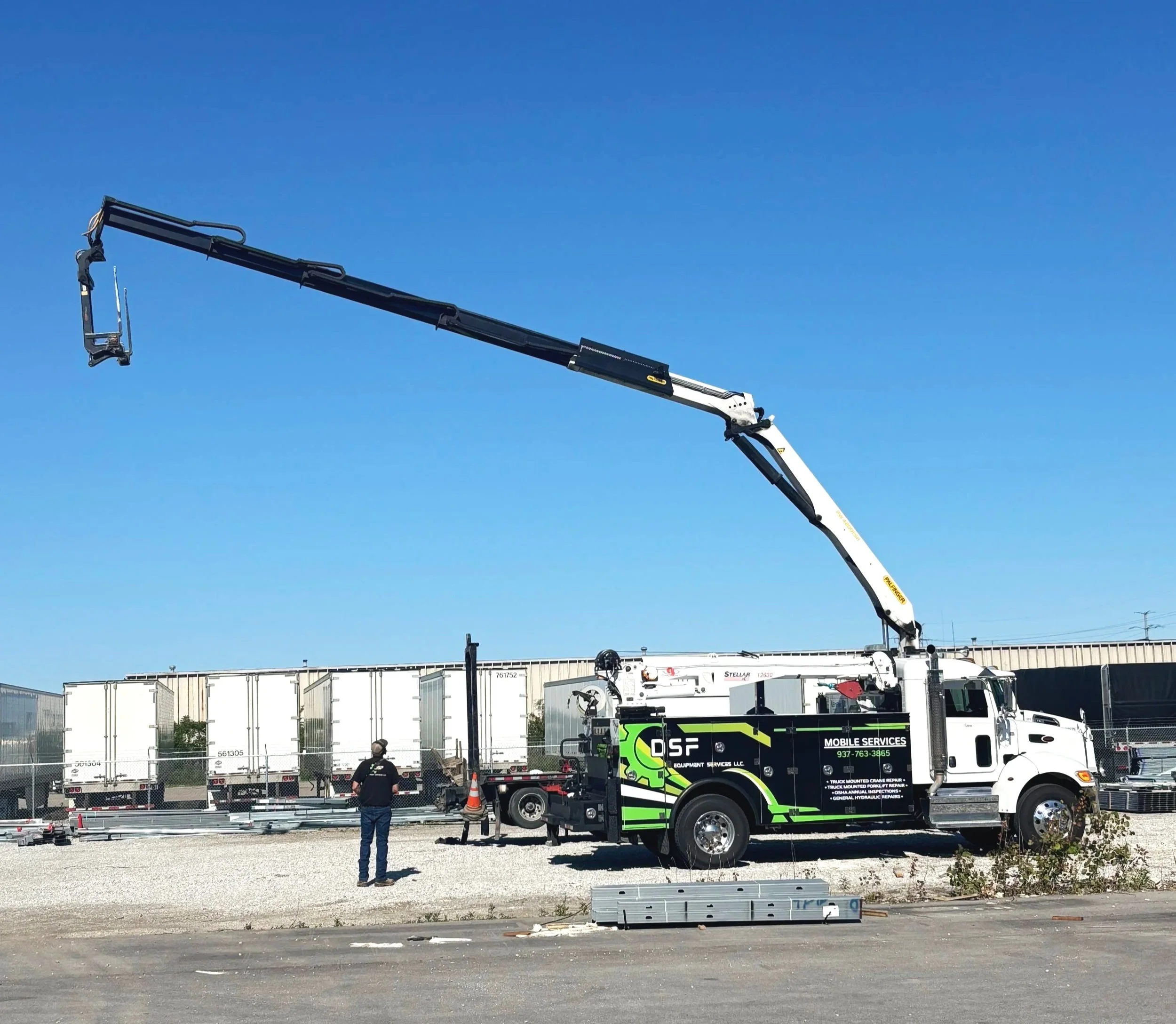 Testing a fully extended articulating knuckle boom crane at a customer's yard.