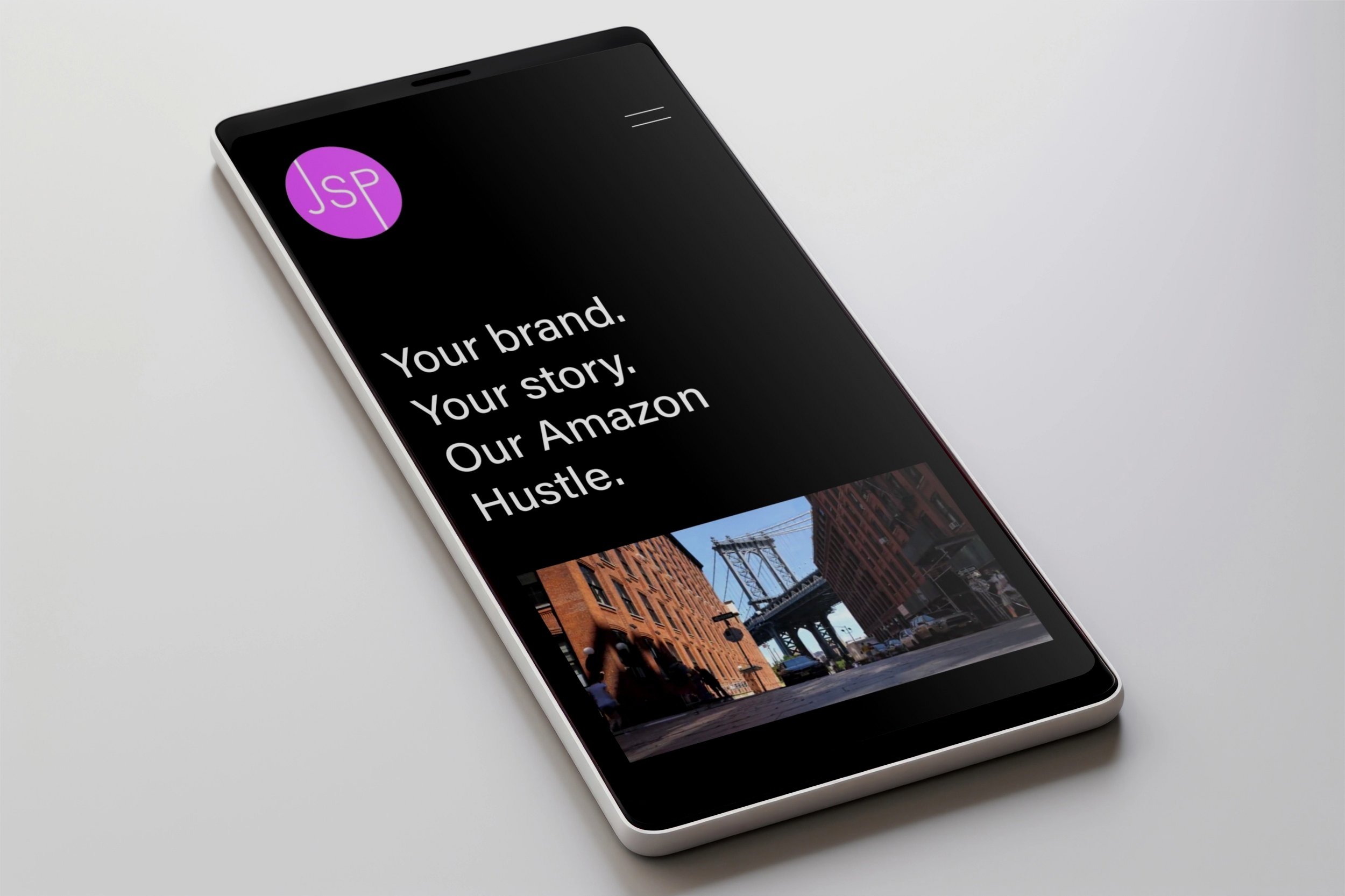 Smartphone displaying a business branding website with the text 'Your brand. Your story. Our Amazon Hustle.' and a cityscape image of the Brooklyn Bridge.