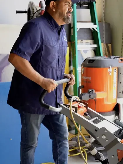 Diamond grinding a warehouse slab with a Husqvarna planetary grinder and dust extractor