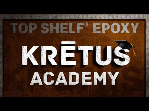 Sign for Kretaus Academy with 'Top Shelf Epoxy' written at the top and a mortarboard icon in the upper right corner.