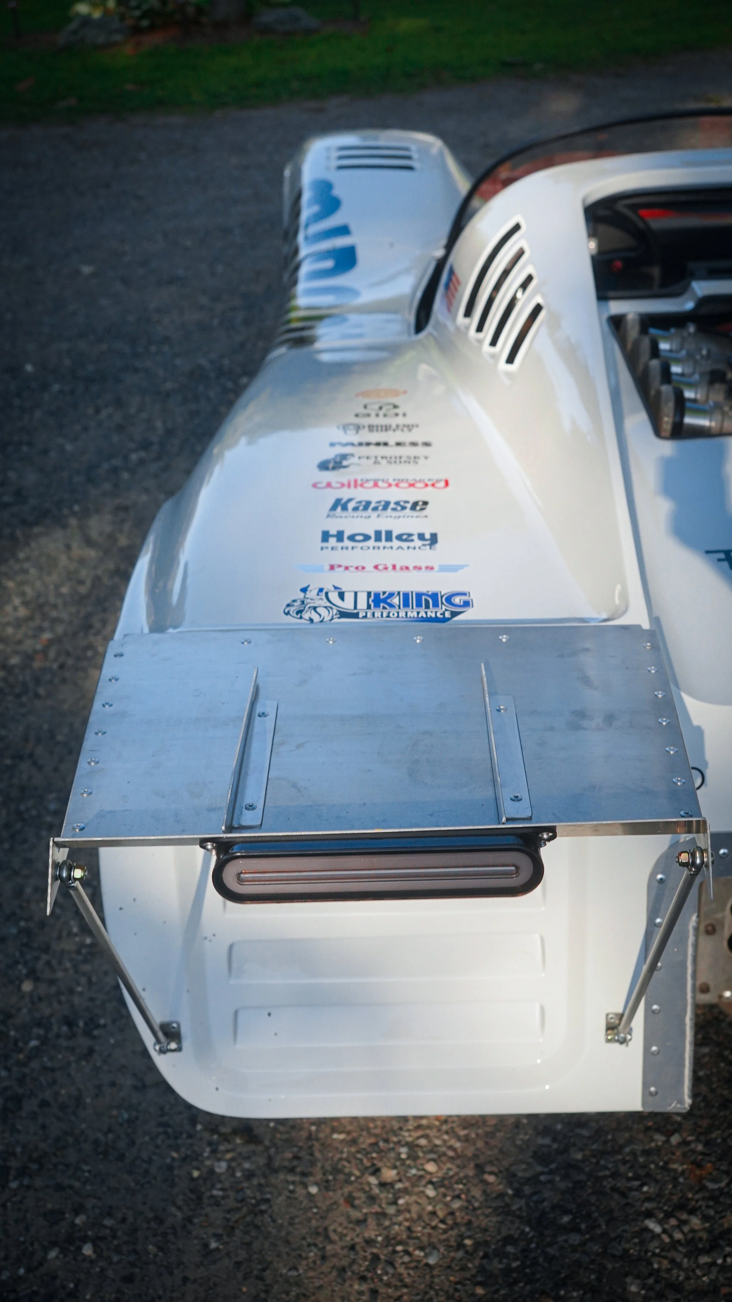 Back of a race car with sponsor decals including Viking Performance and Holley, featuring a metallic panel and a rear wing.
