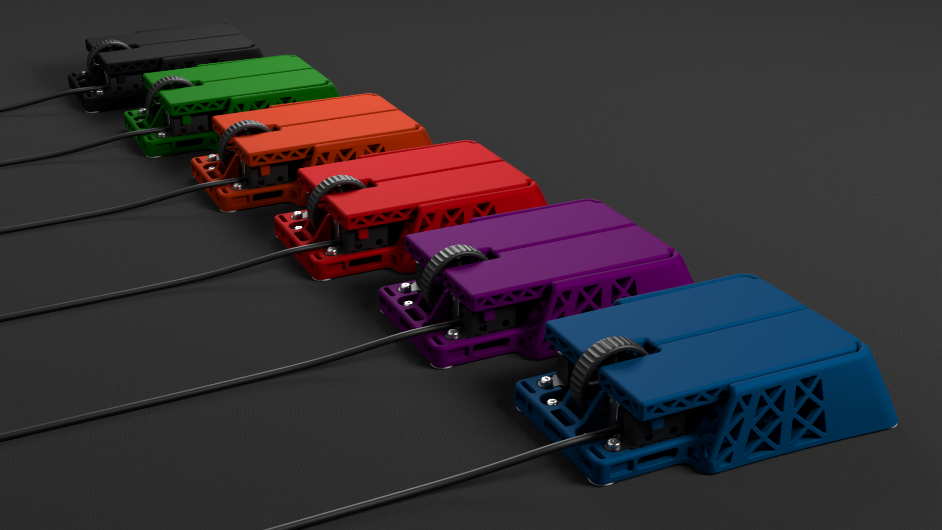 A lineup of six colorful computer mice in black, green, orange, red, purple, and blue, on a flat black surface, with cords extending from each mouse.