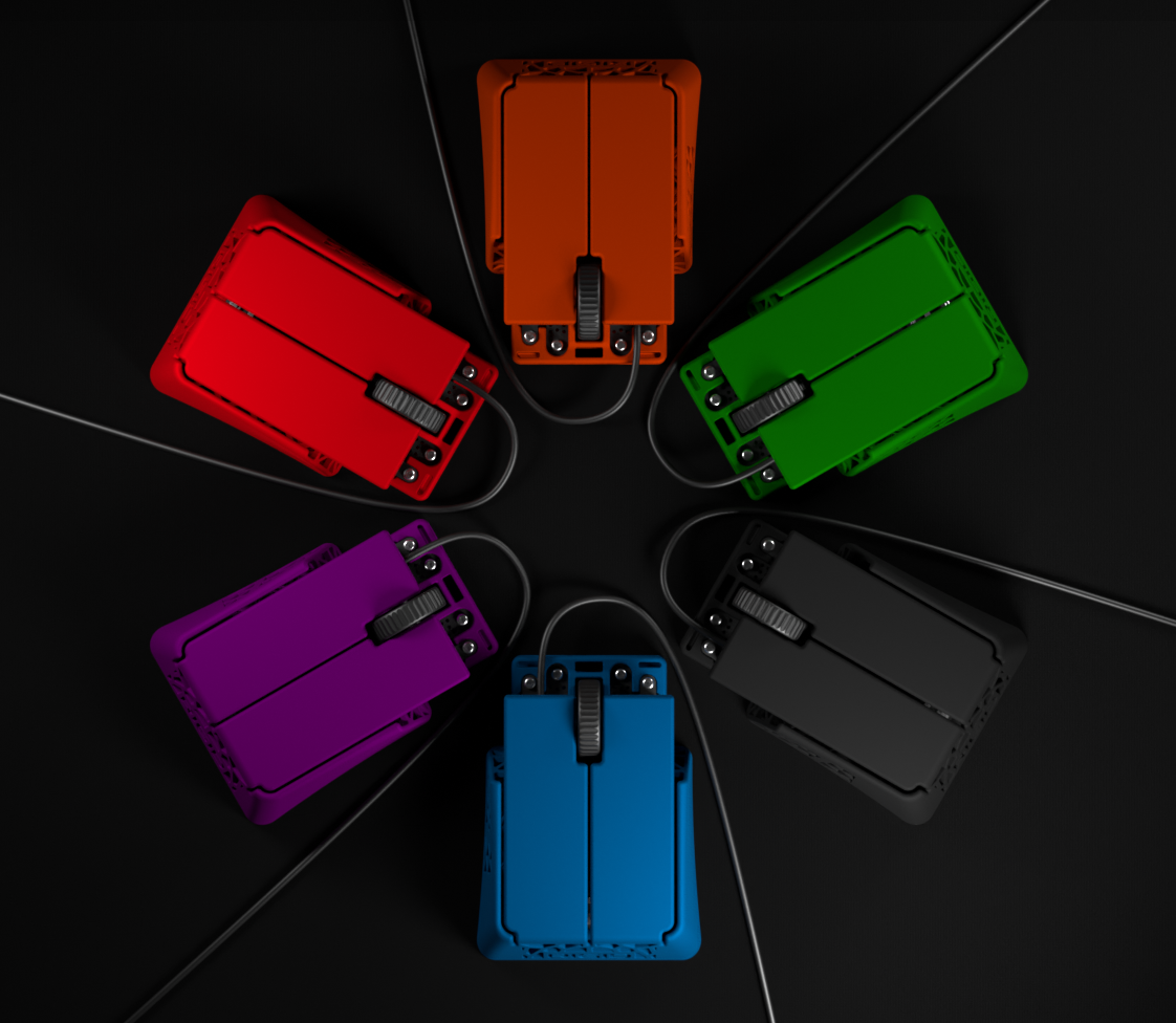 Six colorful computer mice connected to wires are arranged in a circle on a black reflective surface, with colors red, orange, green, purple, blue, and black.