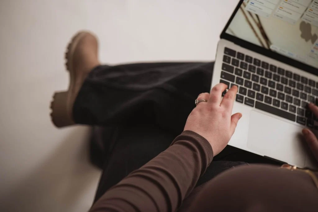 Person using a laptop with a digital map software display.