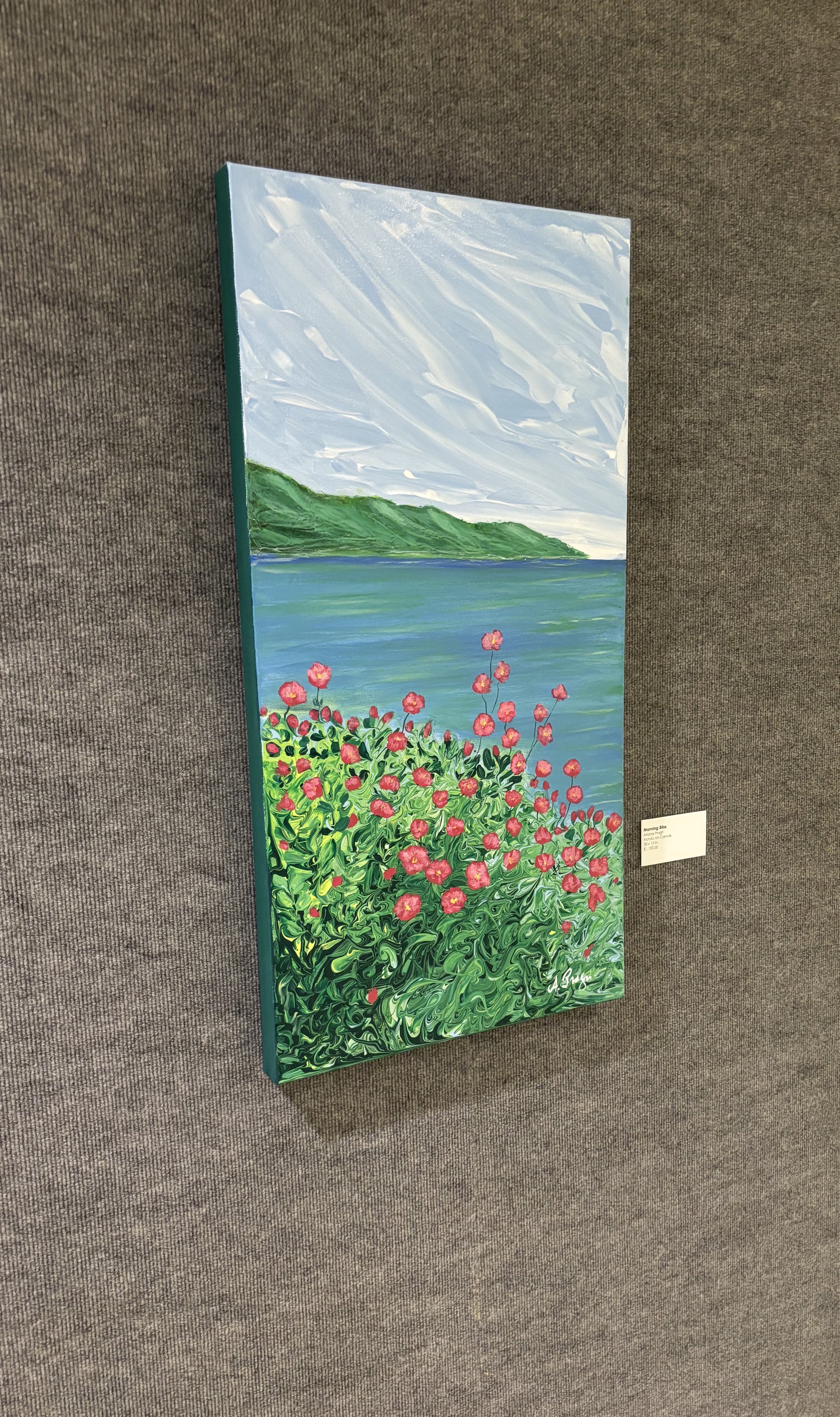 Painting of a landscape with pink flowers, green hills, and a blue lake under a cloudy sky.