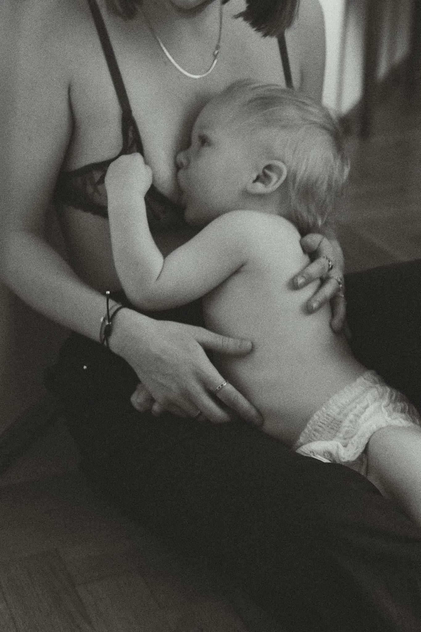 Black and white image of a mother breastfeeding a baby.