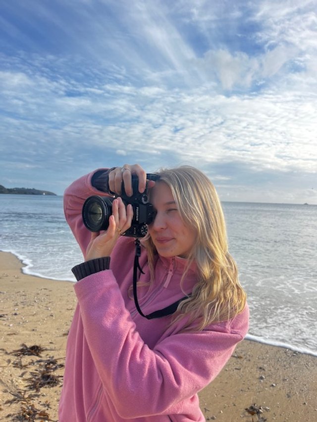 photographer candid photo beach photographer taking photo sunny day