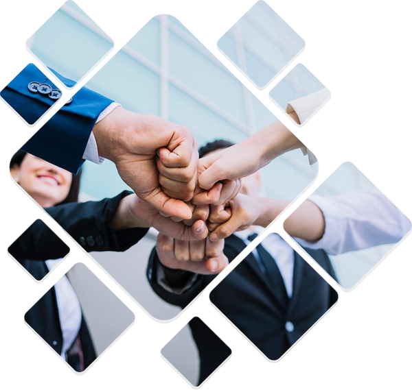 Multiple people in business attire joining their fists together in a group hug.