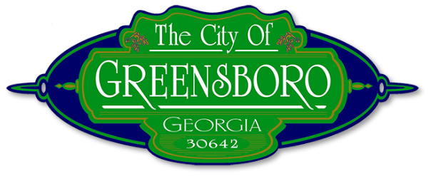 Green and blue city sign for Greensboro, Georgia with the text "The City Of Greensboro Georgia 30642".