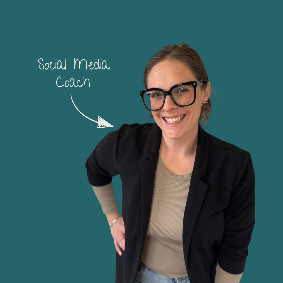 A woman smiling wearing glasses and a black blazer against a teal background. Handwritten text with an arrow points to her, stating "Social Media Coach."