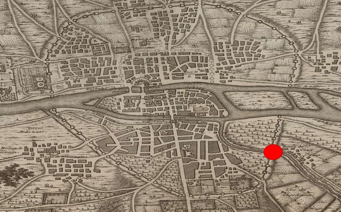 Antique map of a city showing streets, buildings, and waterways, with a red dot marker on the right side.