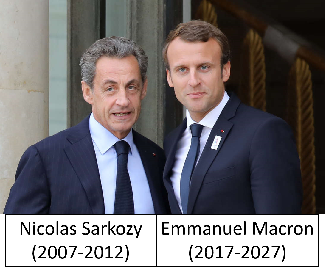 Two men in suits posing together outside a building.