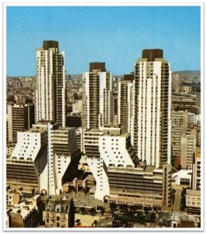 City skyline with high-rise buildings under a clear blue sky.