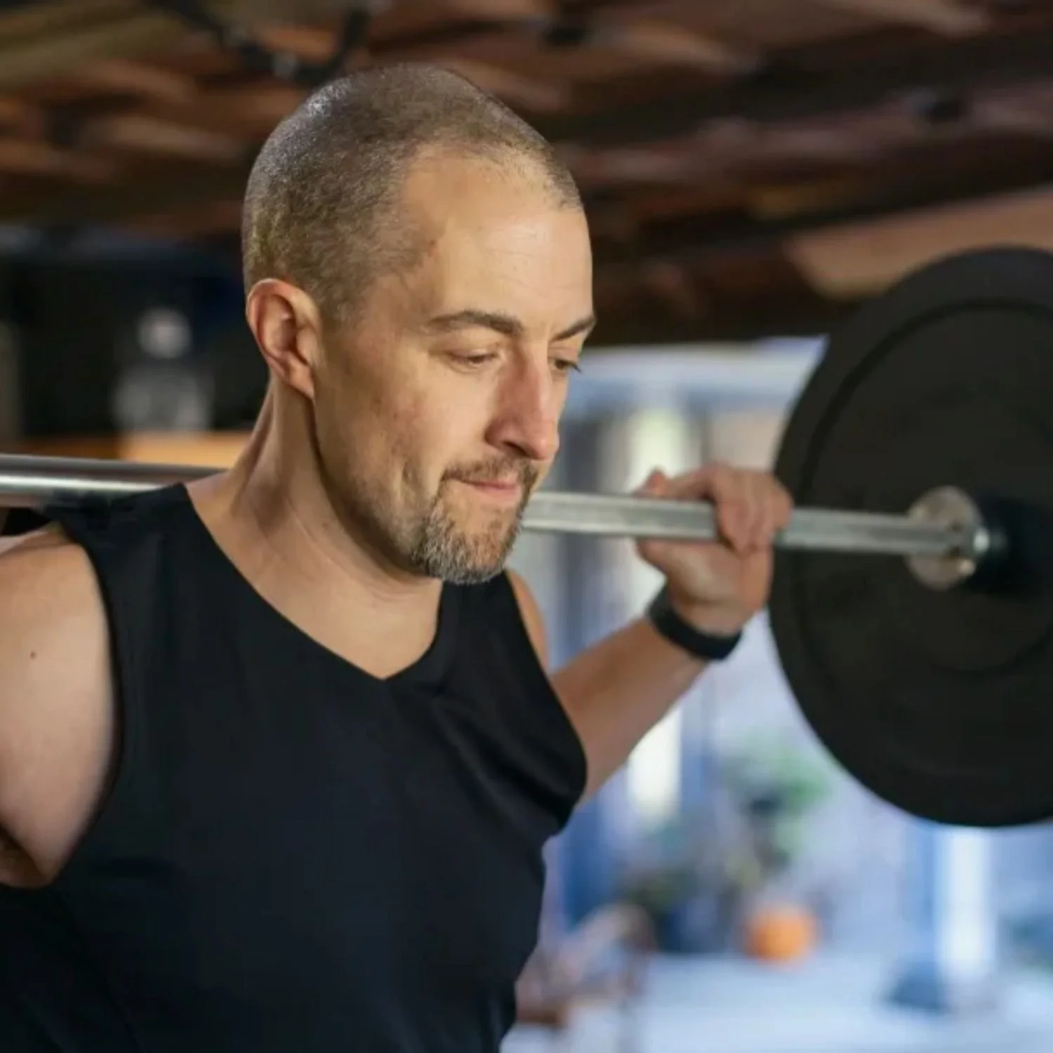 Middle-Aged Man Weightlifting in Gym Setting.jpg