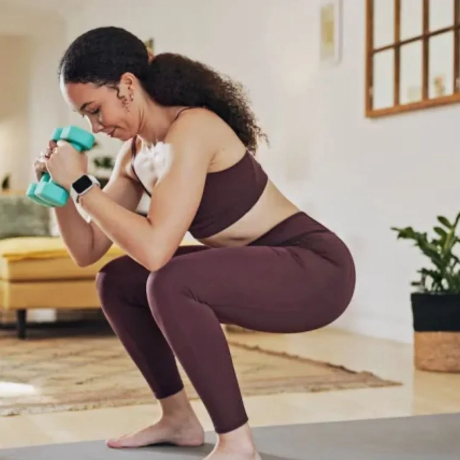 Woman Squatting with Dumbbells During At-Home Workout.jpg