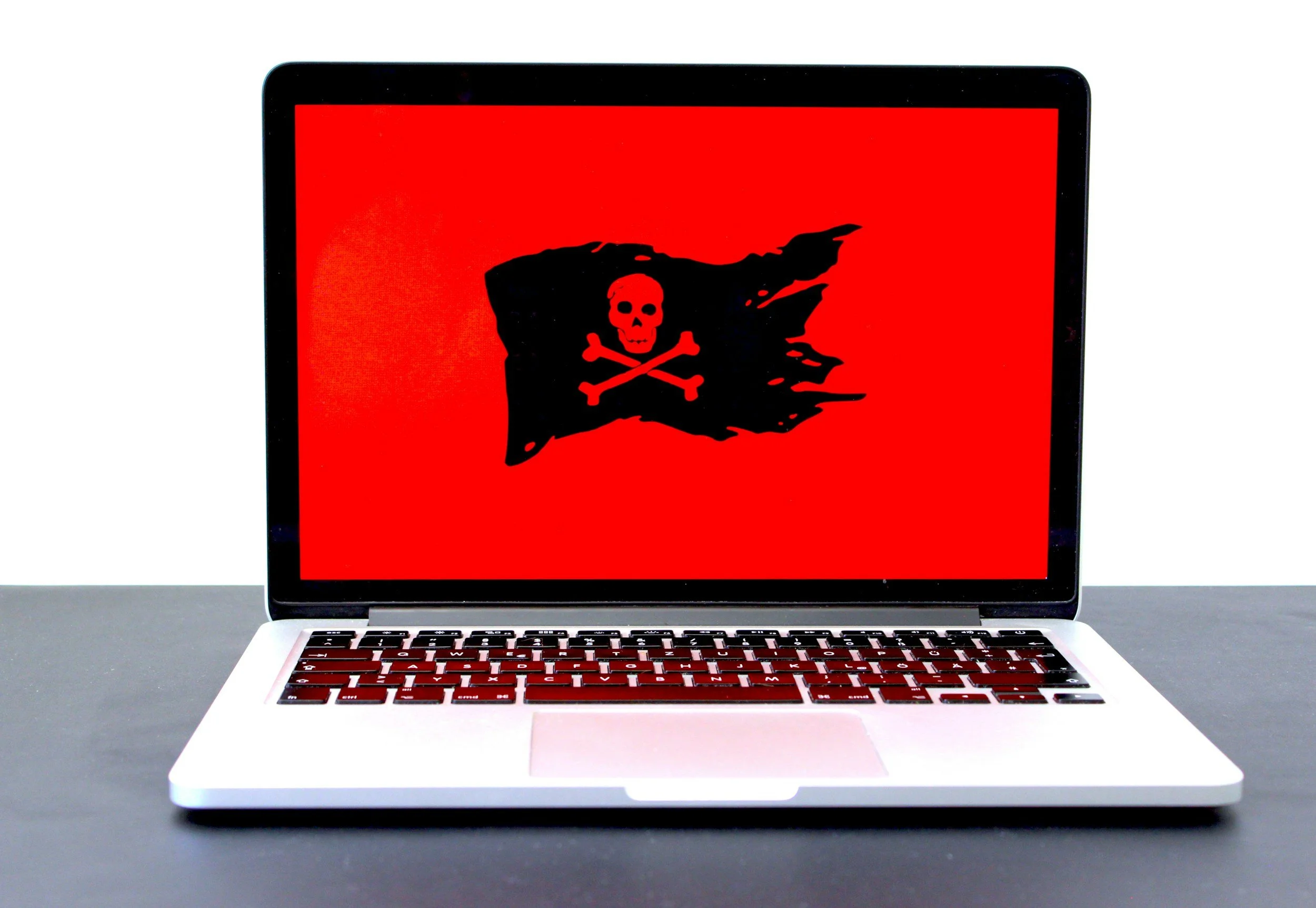 Laptop with Virus Ransomware Pirate on Screen