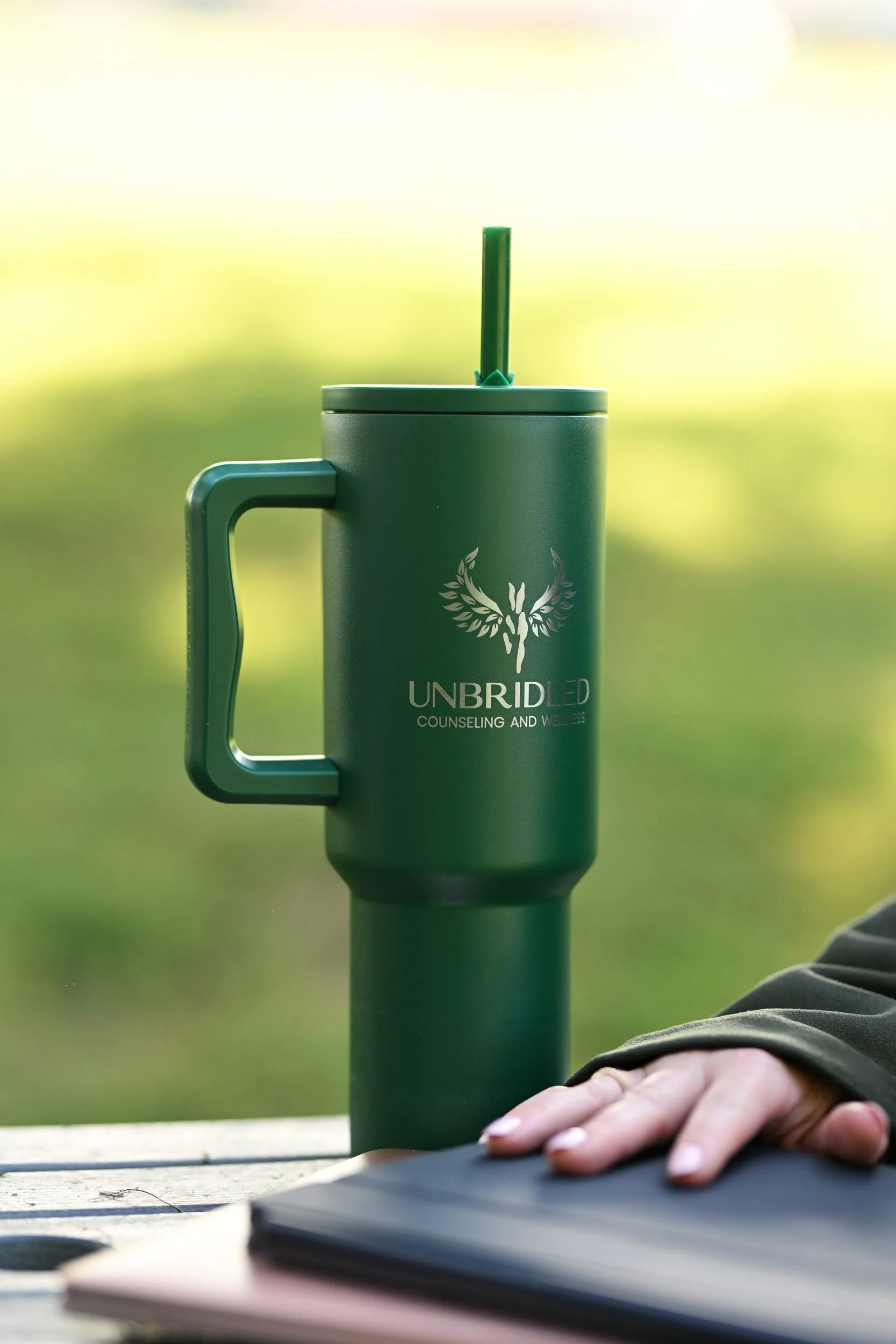 Unbridled Counseling & Wellness tumbler on the office desk